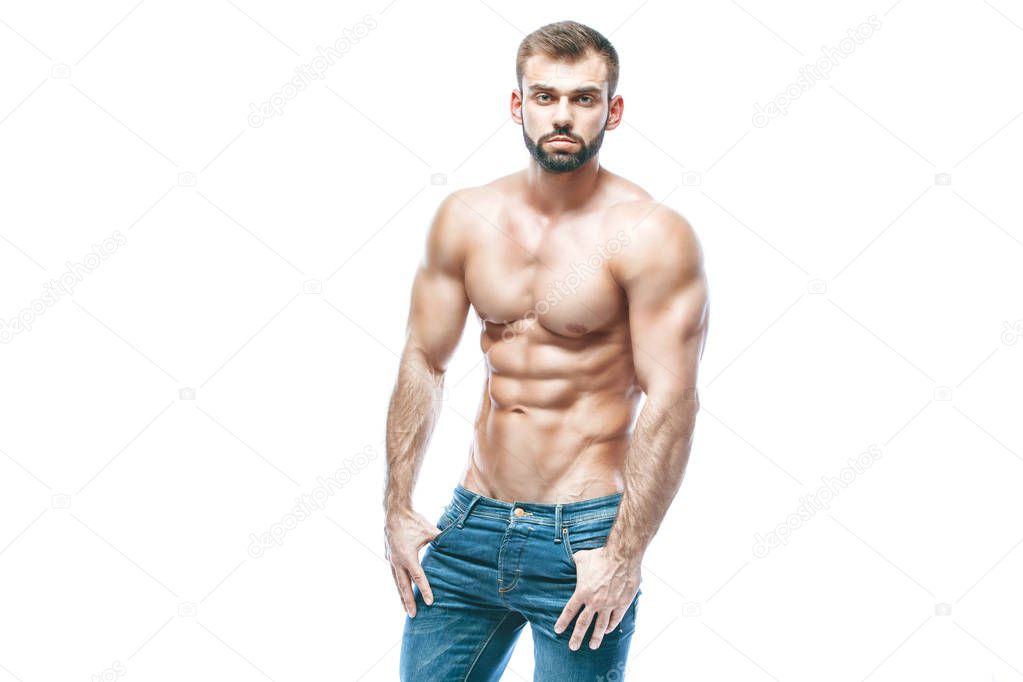 bodybuilder posing. Beautiful sporty guy male power. Fitness muscled in blue jeans. on isolated white background.