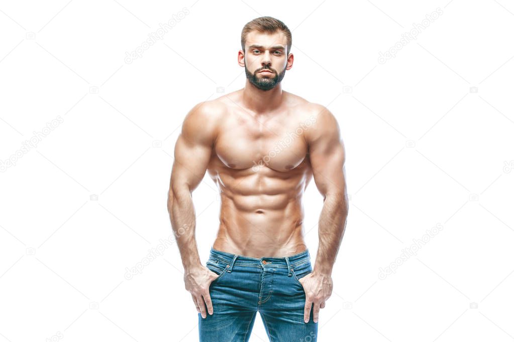 bodybuilder posing. Beautiful sporty guy male power. Fitness muscled in blue jeans. on isolated white background.