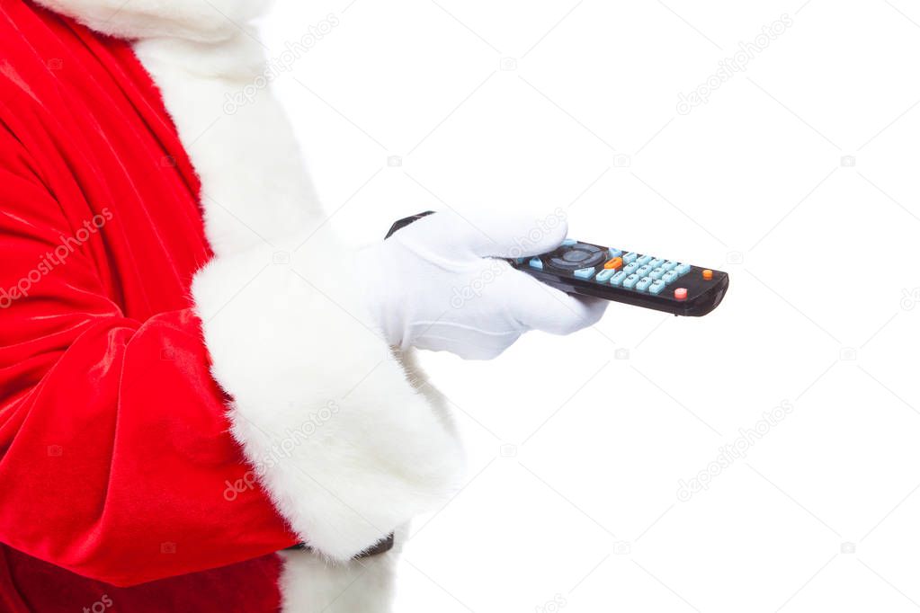 Christmas. Close-up. Santa Claus in white gloves holding the TV remote control. Browse Christmas TV listings, select the channel. Isolated on white background.