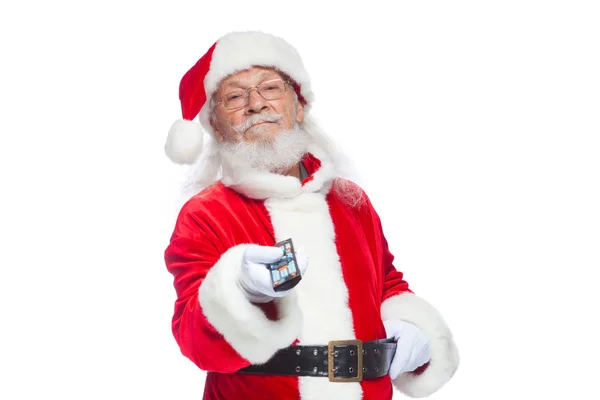 Christmas. Santa Claus in white gloves holding a TV remote control. Browse Christmas TV listings, select the channel. Isolated on white background. — Stock Photo, Image