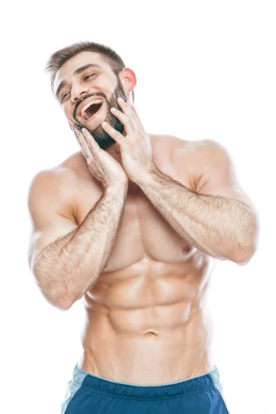 He stroked and touched his beard. A beautiful beard. Beautiful sporty guy male power. Fitness muscled in blue shorts. on isolated white background. — Stock Photo, Image