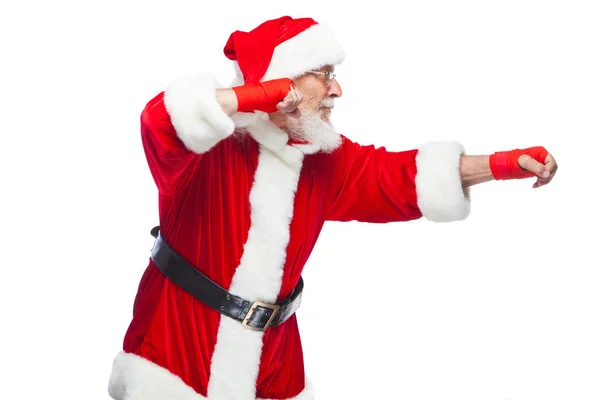 Christmas. Santa Claus with red bandages wound on his hands for boxing imitates kicks. Kickboxing, karate, boxing. Isolated on white background. — Stock Photo, Image