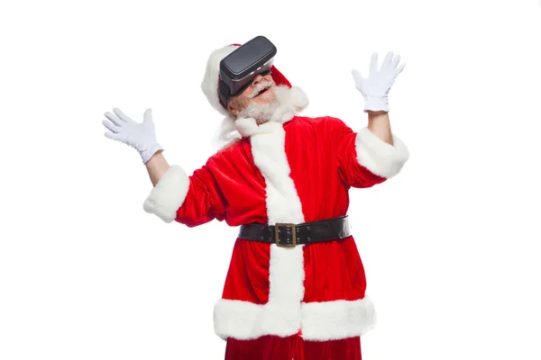 Christmas. Santa Claus in black virtual reality glasses makes gestures with his hands. Surprise, emotion. New technology. Isolated on white background. — Stock Photo, Image