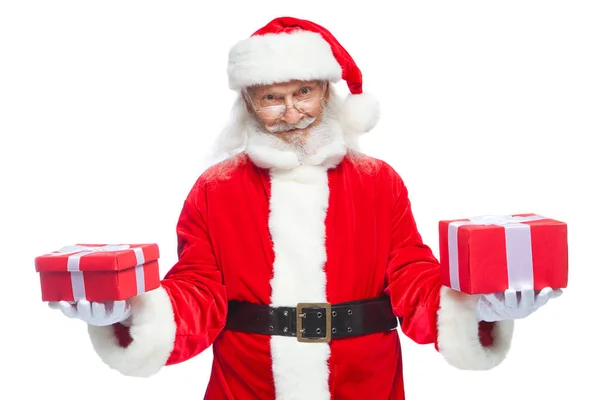 Christmas. Smiling Santa Claus in white gloves holds two boxes with gifts. The concept of choosing a gift, generous gifts. Isolated on white background. — Stock Photo, Image