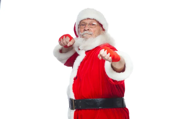 Christmas. Santa Claus with red bandages wound on his hands for boxing imitates kicks. Kickboxing, karate, boxing. Isolated on white background. — Stock Photo, Image