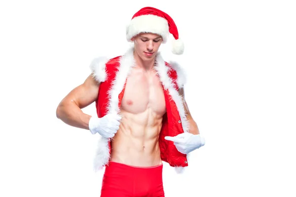 Sexy Santa Claus. Un joven musculoso con sombrero de Santa Claus demuestra sus músculos. Aislado sobre fondo blanco. —  Fotos de Stock