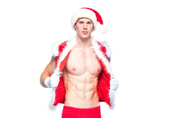 Pai Natal sexy. Jovem homem musculoso usando chapéu de Papai Noel demonstrar seus músculos. Isolado sobre fundo branco. — Fotografia de Stock