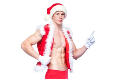 Seksi Noel Baba beyaz boş oturum açma işaret. Genç kaslı adam giyen Santa Claus şapka kasları göstermektedir. Beyaz arka plan üzerinde izole.