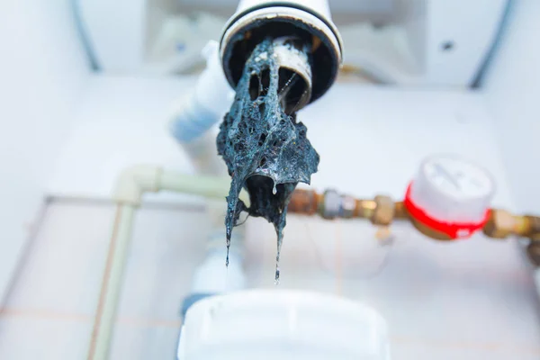 Clogged sink pipe. Unclog a drain from hairs and other stuff. Checking Hydraulic trap for draining water under the sink in the bathroom. Hydraulic problems, works related to the leaking tap. — Stock Photo, Image