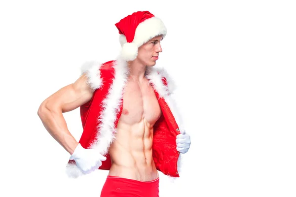 Sexy Père Noël. Jeune homme musclé portant le chapeau du Père Noël démontrer ses muscles. Isolé sur fond blanc. — Photo
