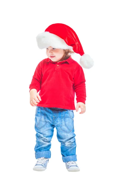 Різдво. Хлопчик в Санта капелюх, куртку червоні і сині джинси. Ізольовані на білому тлі. — стокове фото