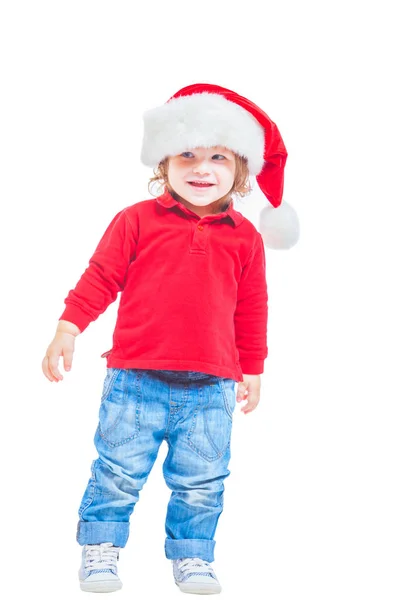 Різдво. Хлопчик в Санта капелюх, куртку червоні і сині джинси. Ізольовані на білому тлі. — стокове фото