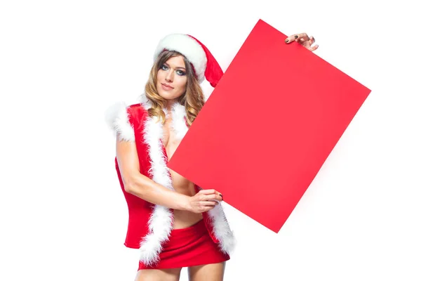 Noël. Belle femme heureuse sexuelle musclée dans les vêtements du Père Noël. Garde le tableau blanc vide. Isolé sur fond blanc . — Photo