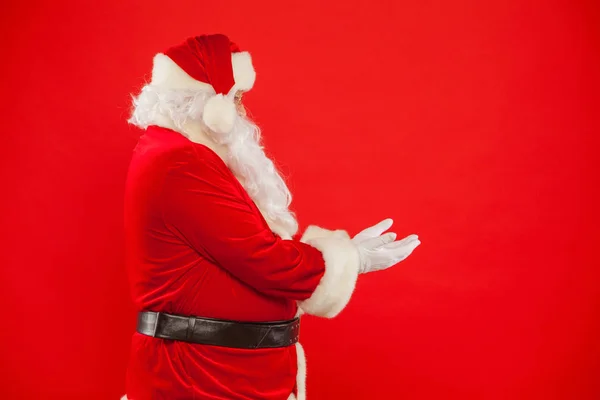 Weihnachtsmann zeigt auf einen leeren Platz, roter Hintergrund — Stockfoto