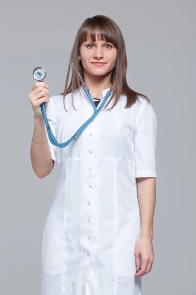 Retrato de una hermosa doctora de pie con estetoscopio — Foto de Stock