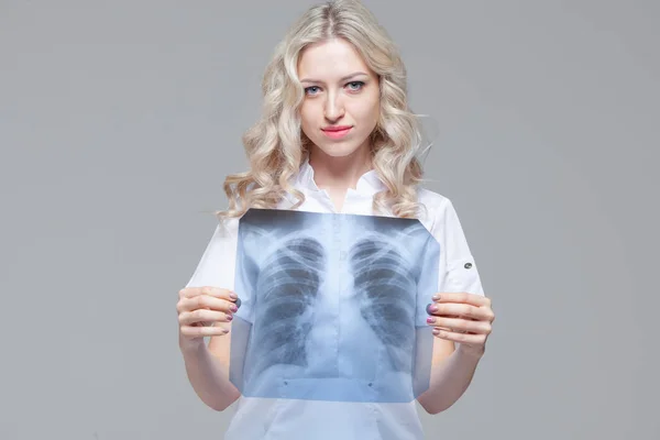 Doctora joven mirando la radiografía de los pulmones —  Fotos de Stock