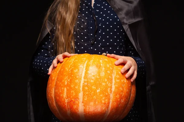 Halloween boszorkány sütőtök a fekete háttér. Gyönyörű fiatal meglepett nő boszorkányok kalap és jelmez gazdaság sütőtök. Széles Halloween Party Art Design. Copy-beillesztés. Boszorkány kézműves koncepció. Közelről — Stock Fotó