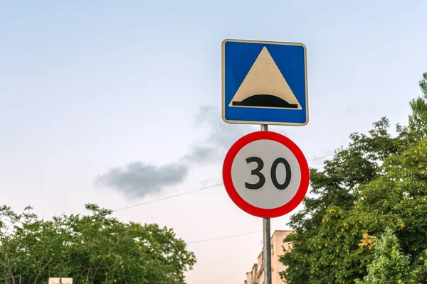 Two road signs against the sky