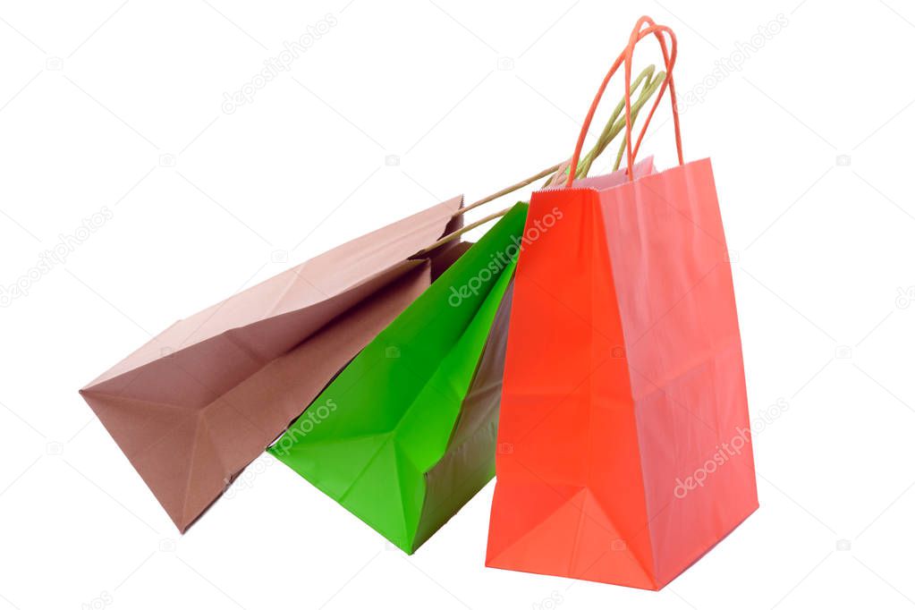 Variety of colored paper shopping bags on white background. Empty area.