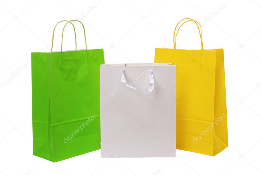 Variety of colored paper shopping bags on white background. Empty area.