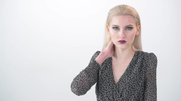 Beautiful young blonde girl with bright makeup. The white background. — Stock Video