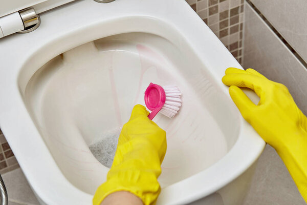 Wash the toilet and clean with a small pink brush. Daily routine.