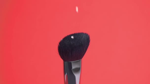 A close-up of a cosmetic brush and a foundation is dripping on it. — Stock Video