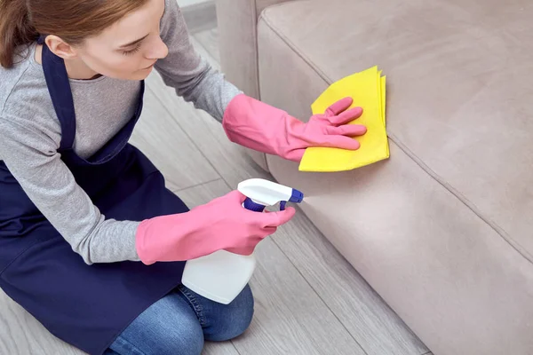 Aplicar um agente de limpeza, produtos químicos domésticos, spray para móveis . — Fotografia de Stock