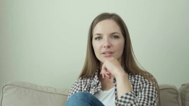 Kanepede oturan bir kadın internet üzerinden video görüşmesiyle iletişim kuruyor. 4k video