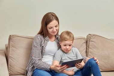 Bir anne anaokulundaki çocuğunu evde online olarak eğitir. Okul hazırlığı.