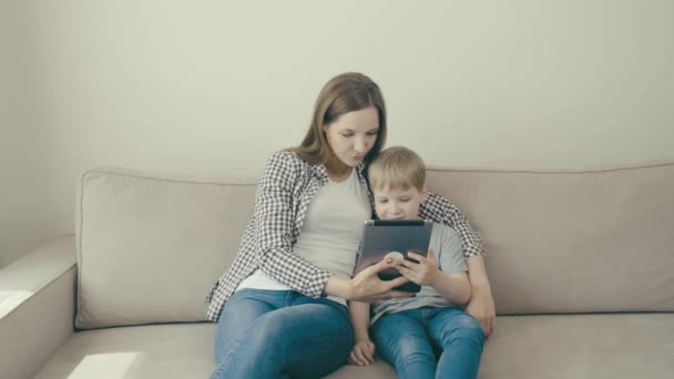 Mamá e hijo juegan juntos en la tableta. Juegos educativos. Vídeo 4k — Vídeo de stock