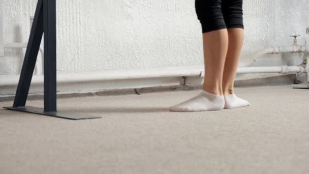 Close up of legs stretching before dancing class. Legs in white socks. — Stock Video