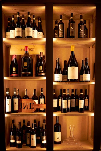 Large wooden shelf with wine in the restaurant. Milan Italy. 08.2020 — Stock Photo, Image