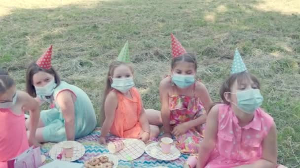 의료용 마스크를 착용하고 공원에서 생일을 축하하는 일단의 소녀들. — 비디오