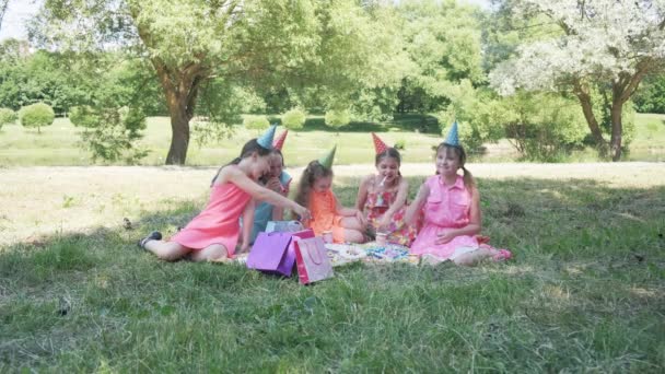 The birthday girl blows the festive whistle and it flies out of her mouth. Video — Stock Video