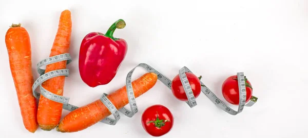 a set of vegetables and a tape to measure body volume, the concept of cleansing the body and healthy eating, vegetarianism and separate nutrition, diet and proper fitness nutrition, nutrition plan