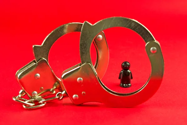 handcuffs and the arrest of a black man, antisemitism and racism, racial discrimination and violation of human rights, law and order, crime and punishment