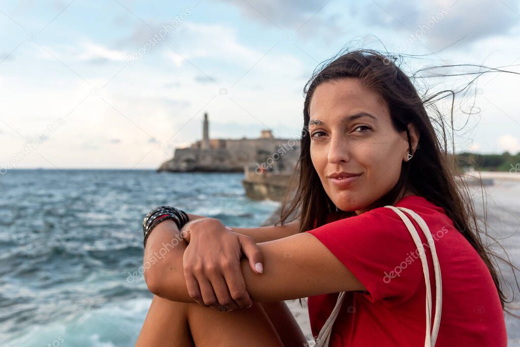 Portrait of woman relaxing on The Malecon, Havana, Cuba