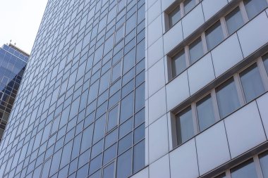 Gökdelenler, gökdelenlerin taban manzarası. Ofis binalarının mimarisi, otel. Çok katlı bir binanın birçok penceresi, zeminleri.