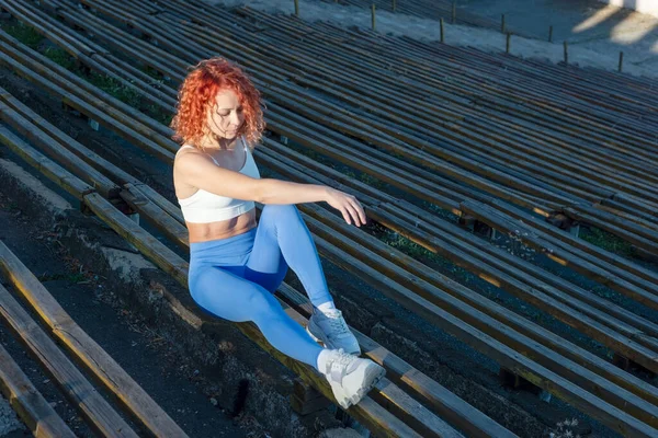 Young Red Haired Sportswoman Sitting Wooden Bench Sports Stadium Beam — Stock Photo, Image