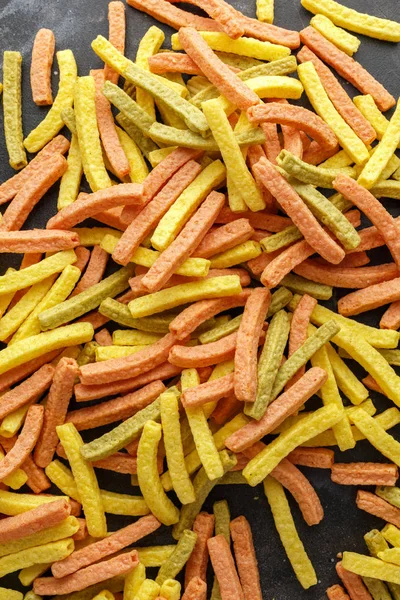 Vegetable healthy crisps, veggie chips, straws, puffs made of broccoli, beetroot, tomatoes, spinach and carrots with sea salt