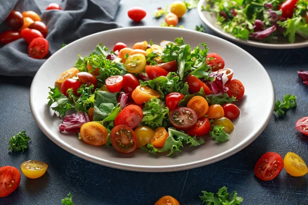 Fresh Cherry Tomato mix salad with lettuce, lemon, lime, black pepper and sea salt. healthy food