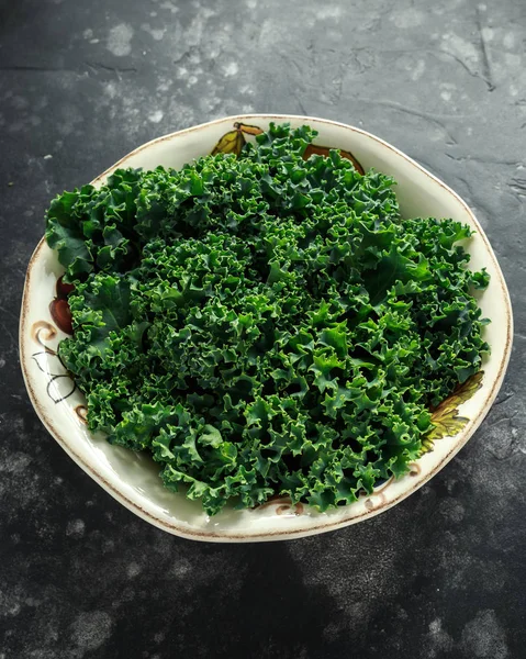 Col rizada verde recién recogida orgánica cruda en un plato —  Fotos de Stock