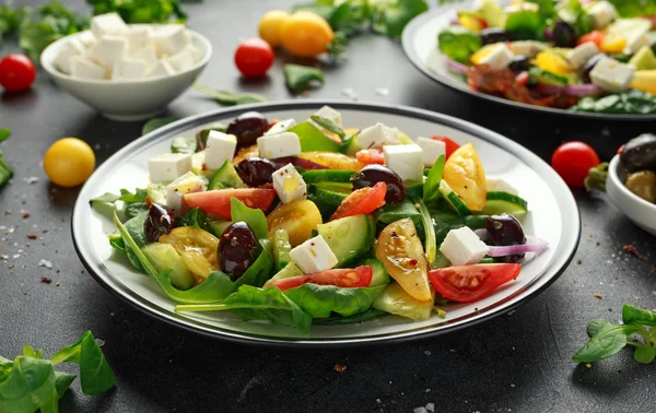 Friss görög saláta uborka, cseresznye paradicsom, saláta, vörös hagyma, feta sajt és fekete olajbogyó. Egészséges táplálkozás — Stock Fotó