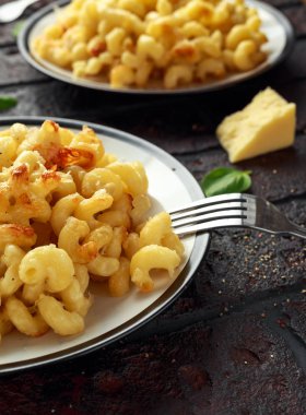 Homemade baked macaroni and cheese with cheddar served on plate clipart
