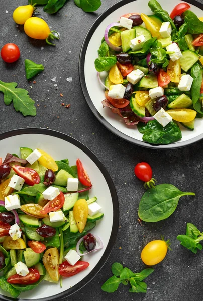 Свежий греческий салат с огурцом, помидорами черри, салатом, красным луком, сыром фета и черными оливками. Здоровое питание — стоковое фото