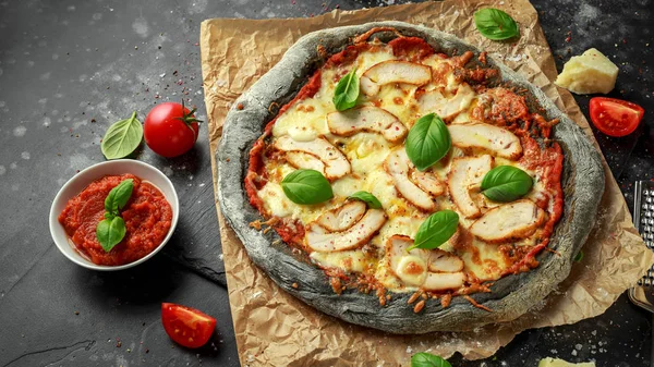 Stone Baked Black Pizza with chicken, tomato and mozzarella cheese