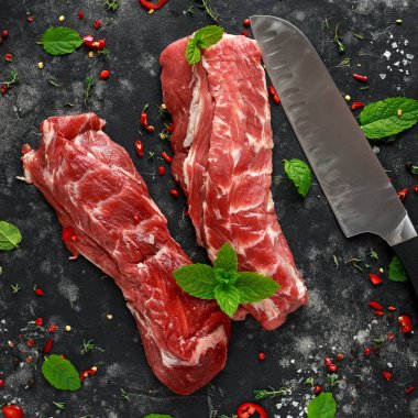 Raw lamb shoulder fillets with chilli, thyme and mint leaves clipart