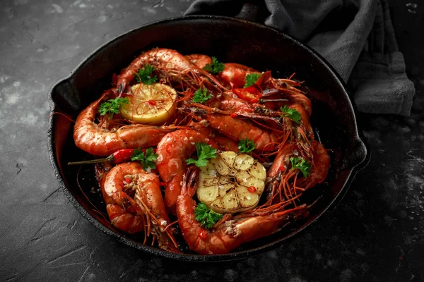 Tiger prawns fried in butter with, lemon juice, garlic and white wine served in cast iron skillet with parsley.