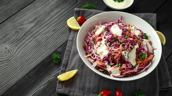 Coleslaw salad with red, white cabbage, carrot, parsley, sesame seeds. served with mayonnaise and lemon.